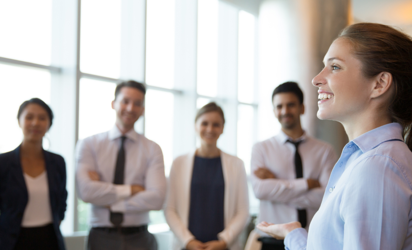 A group of business people in a meeting room, with a recruiting company.